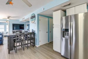 a kitchen and dining room with a stainless steel refrigerator at 1 Block to Surfside Beach: Home w/ Deck! in Freeport