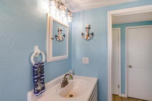 a bathroom with a sink and a mirror at 1 Block to Surfside Beach: Home w/ Deck! in Freeport +24 photos