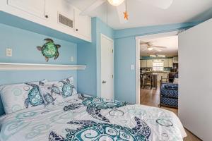 a bedroom with blue walls and a bed at 1 Block to Surfside Beach: Home w/ Deck! in Freeport