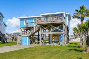 a house with a deck on the beach at 1 Block to Surfside Beach: Home w/ Deck! in Freeport