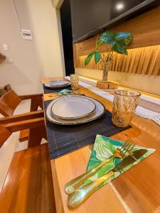 a wooden table with a plate and a fork and knife at Estancia Dorada in San Ramón +6 photos