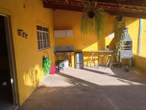 a yellow building with a table and a patio at Casa Amarela in Pouso Alegre +4 photos