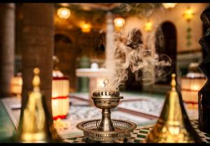 a fountain with smoke coming out of it on a table at Riad Rafeef in Essaouira