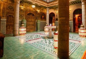 a room with a fountain in the middle of a building at Riad Rafeef in Essaouira