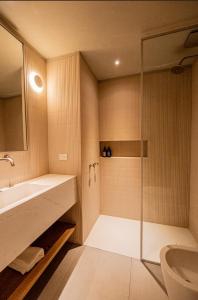 a bathroom with a glass shower and a sink at CasaChica Hotel in José Ignacio +38 photos