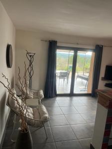 a living room with a view of a patio at Lavandaline in Entrecasteaux