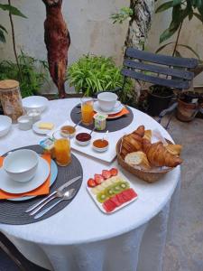 a white table with breakfast foods on it at Ô Anges in Arles