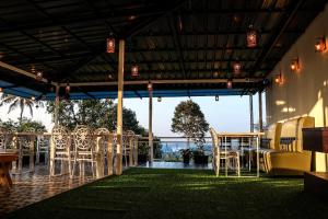 a group of chairs and tables in a pavilion at Misty Bean Resort in Meppādi