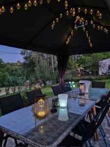 a table under an umbrella with lights on it at Vila Biva in Vrčin