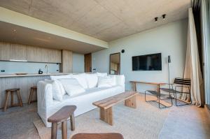 a living room with a white couch and a table at CasaChica Hotel in José Ignacio