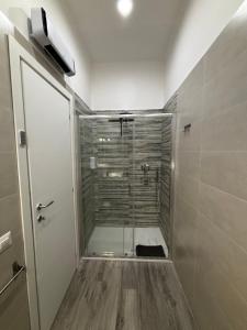 a shower with a glass door in a bathroom at Maison Aielli 112 in San Giuseppe Vesuviano +26 photos
