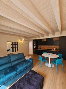 a living room with a blue couch and a table at Case di Daniela in Chiavari