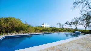 a swimming pool with a view of the ocean at Kavunjeni Villa in Uyombo
