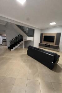 a living room with a couch and a flat screen tv at Casa Bragança in Bragança
