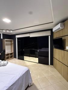 a bedroom with a bed and a flat screen tv at Casa Bragança in Bragança
