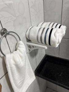 a towel rack in a bathroom with white towels at Casa Bragança in Bragança +56 photos