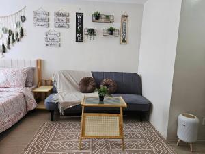 a living room with a couch and a table at BE Residences Lahug in Cebu City