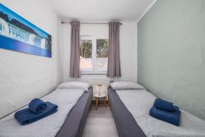 two twin beds in a room with a window at Maleluni in Malinska +69 photos