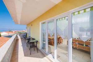 a balcony with a table and chairs on it at Maleluni in Malinska