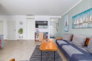 a living room with a couch and a table at Maleluni in Malinska