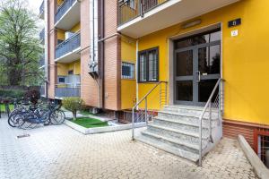 a yellow building with bikes parked outside of it at Colibrì in Milan