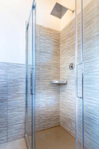 a shower with a glass door in a bathroom at Colibrì in Milan