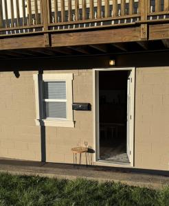 a small table next to a building with a porch at Carolina Suite in Chester