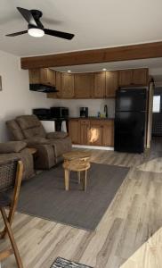 a living room with a couch and a black refrigerator at Carolina Suite in Chester