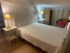 a bedroom with a large bed with a white bedspread at Chateau de Plombières Maison Gauthier Dijon in Plombières-lès-Dijon