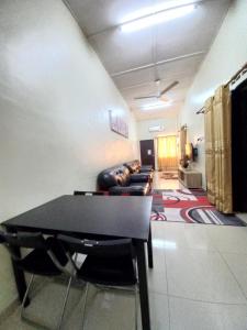 a living room with a table and a couch at Homestay DC 1 - wifi, netflix in Shah Alam +29 photos