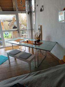 a glass table and a bench in a room at Studio im Krater in Wallerstein
