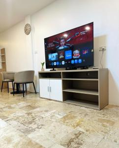 a large flat screen tv sitting on a entertainment center at Brand new furnished studio Apartment near old Town in Phuket +16 photos