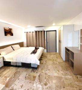 a bedroom with a large bed in a room at Brand new furnished studio Apartment near old Town in Phuket