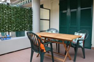 a wooden table and chairs on a patio at Mai senza Mare in Levanto