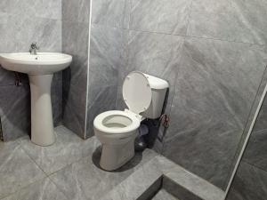 a bathroom with a toilet and a sink at Stush In the Bush in Stegi +6 photos