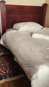 a large white bed with a red headboard at Sky Nest 14 in Nairobi