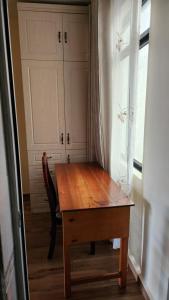 a wooden table and chair in a room with a window at Sky Nest 14 in Nairobi