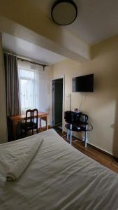 a bedroom with a bed and a television on the wall at Sky Nest 14 in Nairobi
