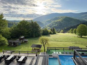 a patio with a view of a field and mountains at Romanka in Żabnica