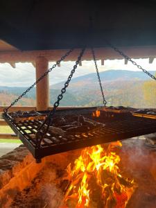 a barbecue grill hanging over a fire at Romanka in Żabnica