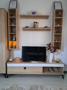 a living room with a television on a table at Mia Apartments in Craiova