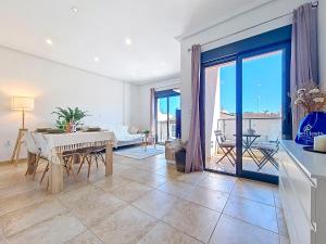 a living room with a table and a dining room at San Pedro Centro - 9110 in San Pedro del Pinatar