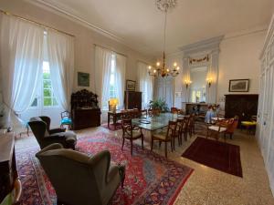 a living room with a table and chairs at Chateau de Plombières Maison Gauthier Dijon in Plombières-lès-Dijon