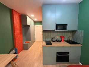 a small kitchen with a sink and a microwave at Premium New Gudauri Apartments with Balcony & Gondola Views in Gudauri