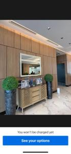 a cosmetics counter with two potted plants in a lobby at Jbs place at Jtower Residences in Mandaue City +32 photos