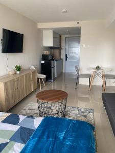 a living room with a table and a kitchen at Jbs place at Jtower Residences in Mandaue City