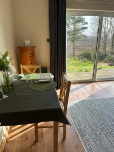 a dining room with a table and a large window at Coiseag at Maol Ruadh, Roy Bridge, near Ben Nevis in Roybridge +24 photos