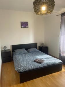 a bedroom with a bed and two night stands at Violette in Bazus