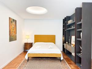 a bedroom with a bed and a book shelf at Mondello Luxury villa in Palermo +35 photos