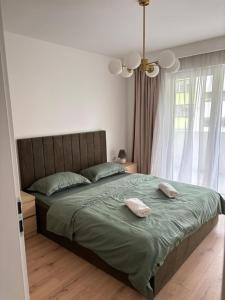 a bedroom with a bed with two pillows on it at Apartament Eroilor Residence in Floreşti